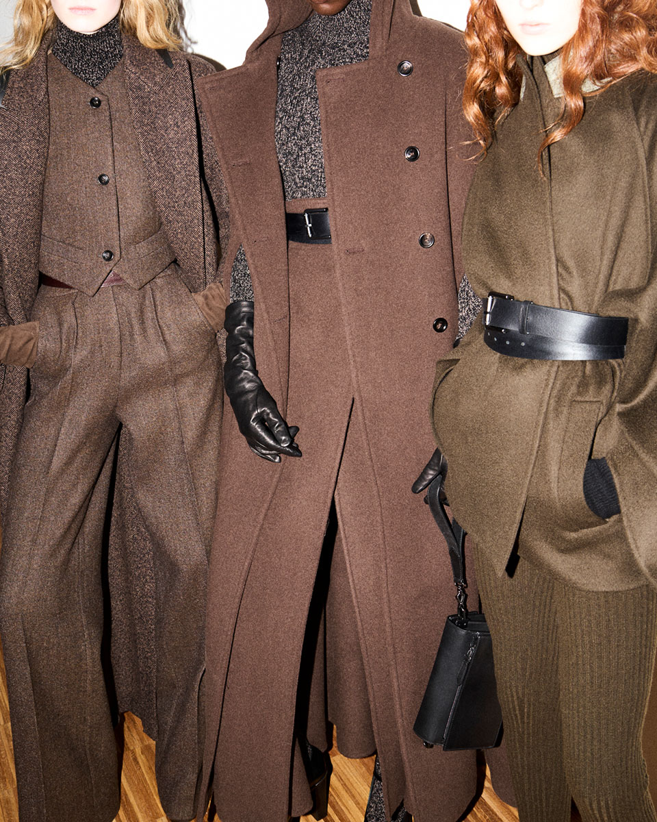 Max Mara Fall/Winter 2025 Fashion Show - Backstage detail shot with three models wearing matching looks.